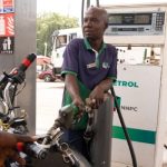 A fuel attendant pumps petrol into a motorcycle at a fuel station in Abuja on March 9, 2026, after transport fares increased following a recent hike in petrol prices. (Photo by Light Oriye Tamunotonye / AFP